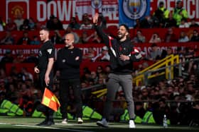 Ruben Amorim, Manager of Manchester United, gestures as Pep Guardiola, Manager of Manchester City, looks on during the Premier League match between Manchester United FC and Manchester City FC at Old Trafford on April 06, 2025 in Manchester, England. 