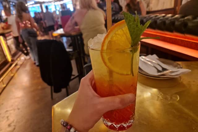 Love Wins features a vibrant and refreshing blend of Stonewall Dry Gin, juicy orange, and exotic passion fruit, brightened with a touch of lemon and a hint of sweet gomme. A splash of Midori adds a touch of melon magic and a beautiful emerald hue, finished with a delicate swirl of grenadine.