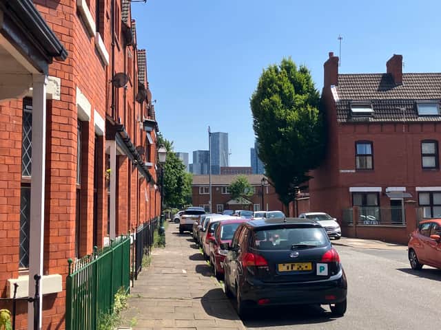 Between the red-brick terraces of Ordsall, Manchester’s glimmering towers come into view