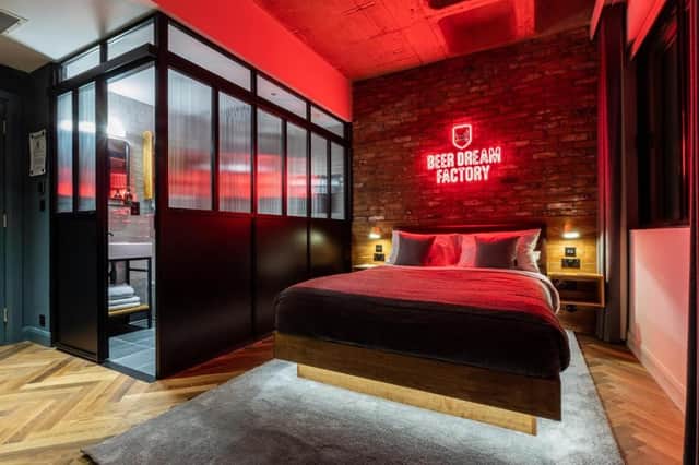 One of the characterful rooms at BrewDog DogHouse Manchester, complete with exposed brick, neon art and playful, beer-inspired touches