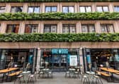 BrewDog DogHouse Manchester stands out with its leafy facade, buzzing outdoor tables and quirky vibe right in the heart of the city