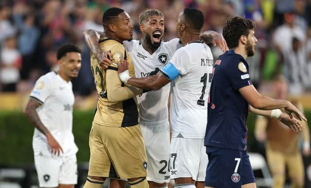 John #12, Alexander Barboza #20, and Marlon Freitas #17 of Botafogo celebrate following the team's victory as Khvicha Kvaratskhelia #7 of Paris Saint-Germain looks on the FIFA Club World Cup 2025 group B match between Paris Saint-Germain FC and Botafogo FR at Rose Bowl Stadium on June 19, 2025 in Pasadena, California.