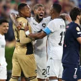 John #12, Alexander Barboza #20, and Marlon Freitas #17 of Botafogo celebrate following the team's victory as Khvicha Kvaratskhelia #7 of Paris Saint-Germain looks on the FIFA Club World Cup 2025 group B match between Paris Saint-Germain FC and Botafogo FR at Rose Bowl Stadium on June 19, 2025 in Pasadena, California. 
