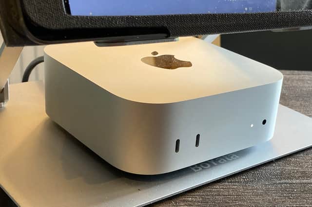 My Apple Mac mini M4 set up neatly under the monitor on my home office desk.