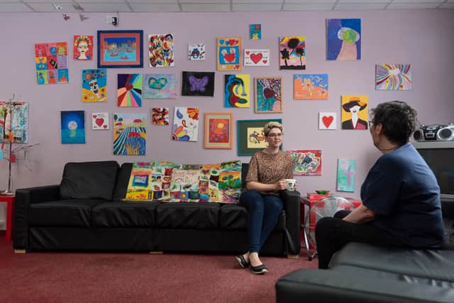 Two people talking on the sofas at the MASH drop-in before it had to close