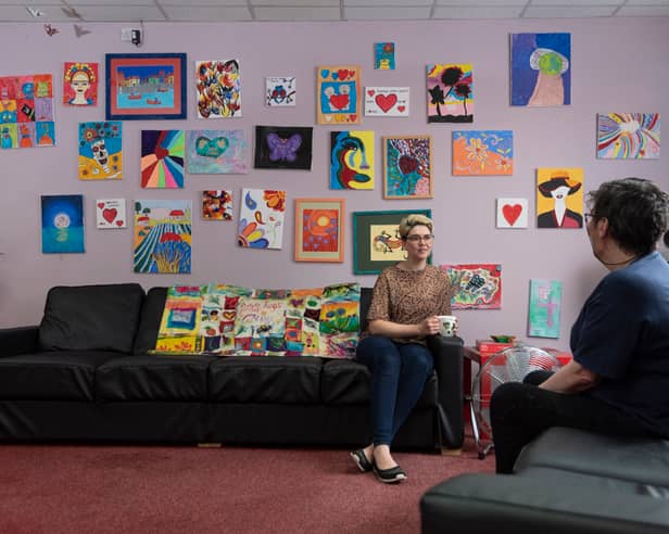 Two people talking on the sofas at the MASH drop-in before it had to close