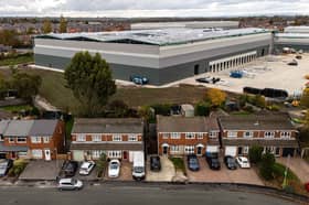 Aerial Images reveal the affects of living next to an enourmous warehouse after cladding was installed blocking light and creating darkness. Residents in Tyldesley, Wigan, described being alarmed by the scale as they watch it develop, with some considering moving