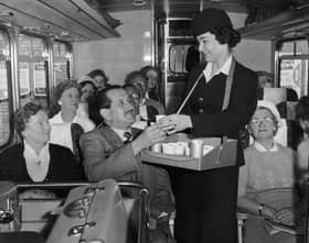 Denise George serves refreshments to passengers on board a 'Gay Hostess' luxury coach service between London, Blackpool and the Lake District in May 1960