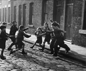 Children play a game of 'cowboys and Indians', in Salford, Lancashire, in 1957