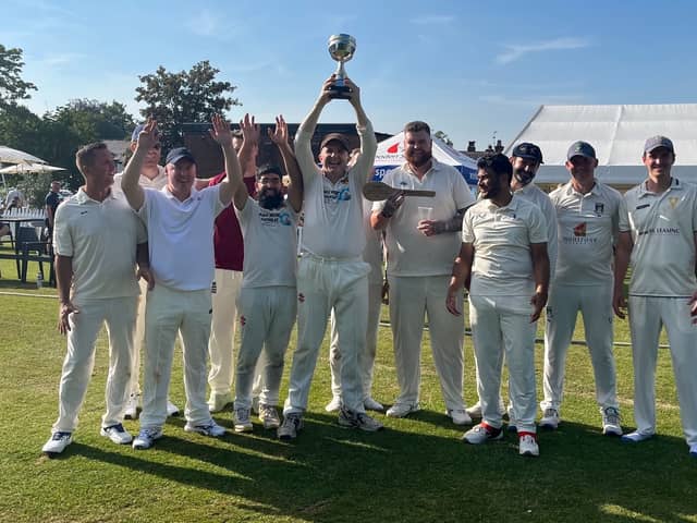 The victorious Sticky Wicket XI, captained by Chris Maguire (holding trophy)