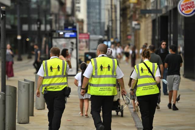 Metrolink workers wear high vis jackets with that urge social distancing as a precaution against the transmission of the novel coronavirus in Manchester