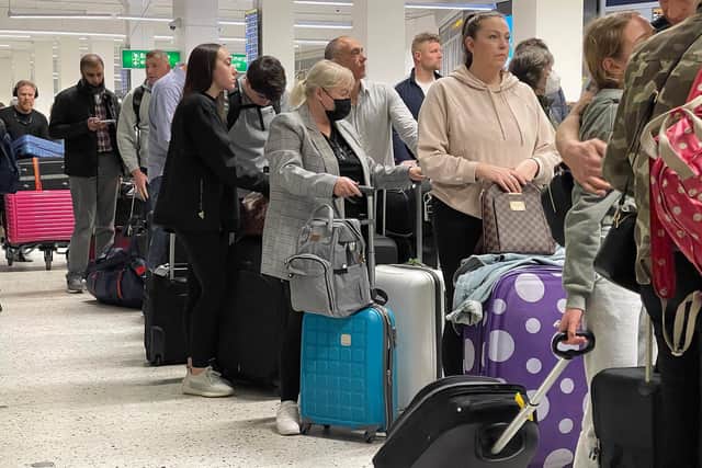 Passengers queue for check-in at Manchester Airport. Photo: Getty Images