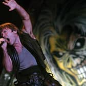 Iron Maiden frontman Bruce Dickinson belts out a hit on stage at Leeds Festival in August 2005.
