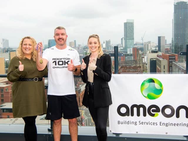 Ameon's Steve McCourt ends the world's first rooftop 10K in aid of the NHS, with a medal from co-organisers, Vox Manchester's Kate Howell, left, and Indea Garlick