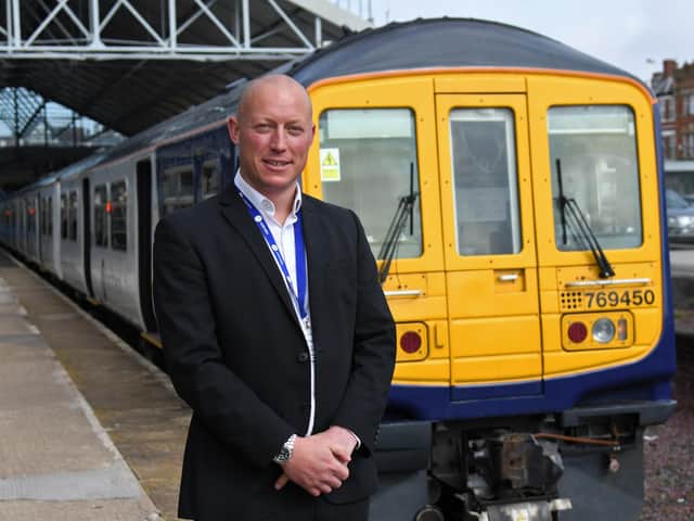 Northern Regional Director Chris Jackson stand with one of Northern's bi-mode 769 trains