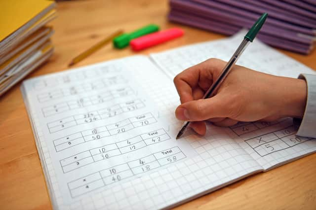 File photo dated 05/03/2017 of a primary school teacher marking a pupil's maths homework. Children in the "best-off" homes were more likely to report having had private tutoring than their peers in the "worst-off" homes (35% compared with 21%), according to the Sutton Trust report. A survey of 2,394 schoolchildren aged 11 to 16 in England and Wales found that 30% said they have had private tuition, up from 27% pre-pandemic. The proportion is the joint highest figure since the survey began in 2005, when it stood at 18%. Issue date: Thursday March 9, 2023.