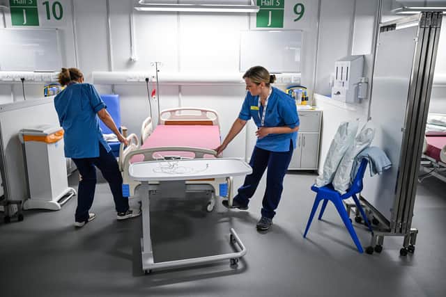 NHS staff preparing the temporary Louisa Jordan field hospital in April 2020. Photo by Jeff J Mitchell/Getty Images