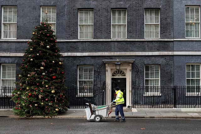 A City of Westminster worker cleans the street in front of 10 Downing Street, the official residence of Britain's Prime Minister, in central London. Picture: Adrian Dennis/AFP via Getty Images