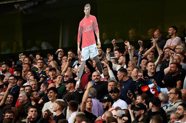 Fans of Manchester United hold up a cardboard cutout of Cristiano Ronaldo during the Premier League match between Wolverhampton Wanderers  and  Manchester United at Molineux on August 29, 2021 in Wolverhampton, England. (Photo by Shaun Botterill/Getty Images)