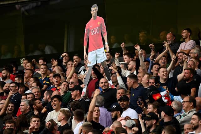 Fans of Manchester United hold up a cardboard cutout of Cristiano Ronaldo during the Premier League match between Wolverhampton Wanderers and Manchester United at Molineux on August 29, 2021 in Wolverhampton, England. (Photo by Shaun Botterill/Getty Images)