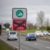 A defaced Greater Manchester Clean Air-Zone warning side