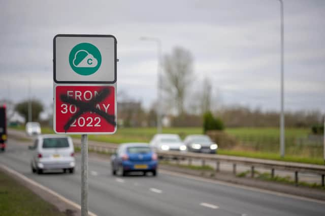 A defaced Greater Manchester Clean Air-Zone warning side