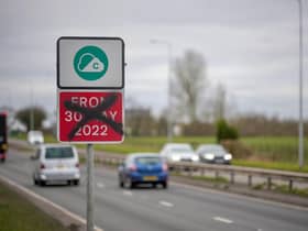 A defaced Greater Manchester Clean Air-Zone warning side