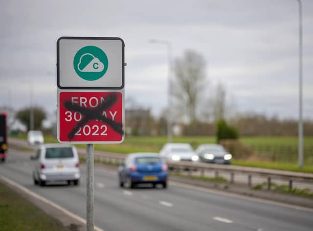 A defaced Greater Manchester Clean Air-Zone warning side, with the old start date amended 