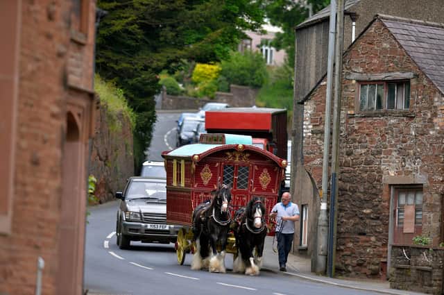 A traveller caravan causes a traffic jam as it passes through Appleby, Cumbria on Day 2 of the Appleby Horse Fair, the annual gathering of gypsies and travellers.