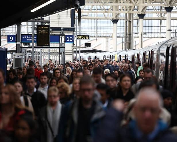 Commuters walk along a packed platform after a single train arrived during the morning rush hour, at Waterloo Station in London on April 8, 2024, as train drivers strike over pay. (Photo by HENRY NICHOLLS / AFP)