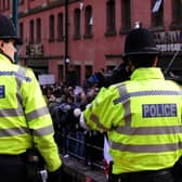 Police watch the English Defence League protesters on the waterfront in Nottingham.