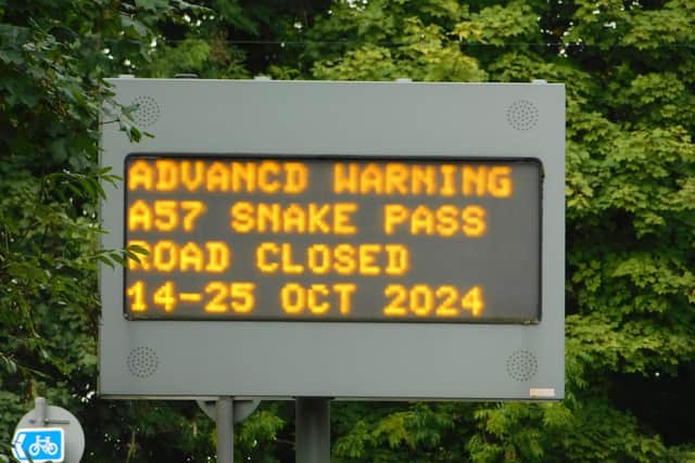 A Snake Pass road closure sign for October 14-25.