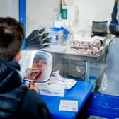 A woman taking a Covid-19 test. Photo: Adrian Dennis/AFP via Getty Images 