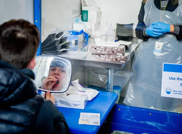 A woman taking a Covid-19 test. Photo: Adrian Dennis/AFP via Getty Images 