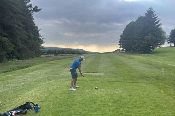 Joshua playing golf at Turton Golf Club