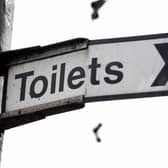 A sign for public toilets in London. Spending by councils in England on basic services such as public toilets, road safety and pest control has fallen as much as 40\% since 2010.