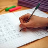 File photo dated 05/03/2017 of a primary school teacher marking a pupil's maths homework. Children in the "best-off" homes were more likely to report having had private tutoring than their peers in the "worst-off" homes (35% compared with 21%), according to the Sutton Trust report. A survey of 2,394 schoolchildren aged 11 to 16 in England and Wales found that 30% said they have had private tuition, up from 27% pre-pandemic. The proportion is the joint highest figure since the survey began in 2005, when it stood at 18%. Issue date: Thursday March 9, 2023.