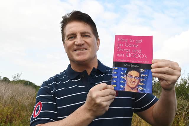 Mike Stratton with his book on how to win big at game shows