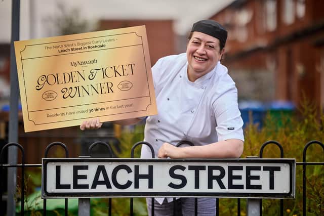 Head Chef Shama Rahman on Leach Street, Rochdale, giving residents golden tickets for a free meal