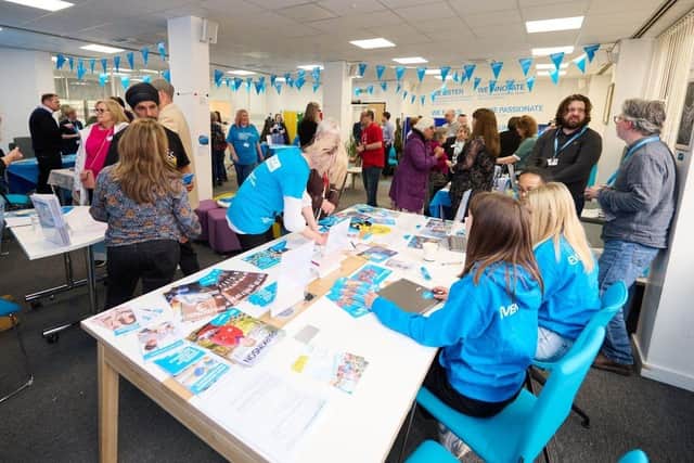 Attendees engaging with Parkinson’s UK staff and volunteers at a previous information event