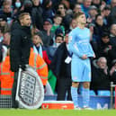 James McAtee with Manchester City manager Pep Guardiola as he prepares to make his Premier League debut for the English champions against Everton in November 2021. (Photo by Alex Livesey/Getty Images)
