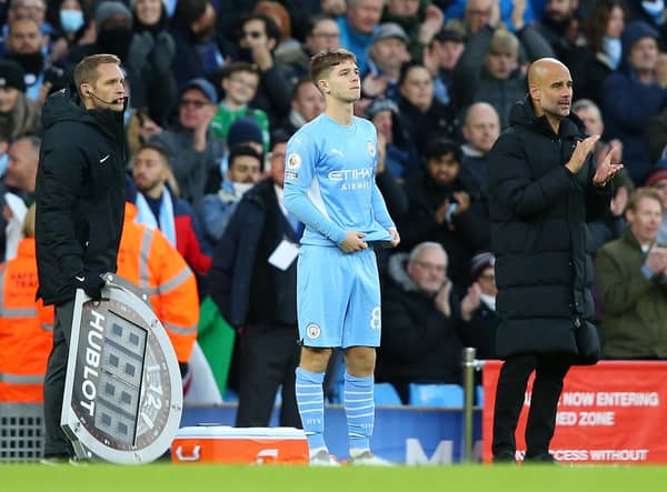 James McAtee with Manchester City manager Pep Guardiola as he prepares to make his Premier League debut for the English champions against Everton in November 2021. (Photo by Alex Livesey/Getty Images)
