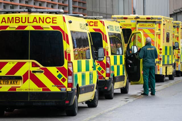 A paramedic walks past a line of ambulances outside the Royal London Hospital, in London. Picture date: Monday December 27, 2021.