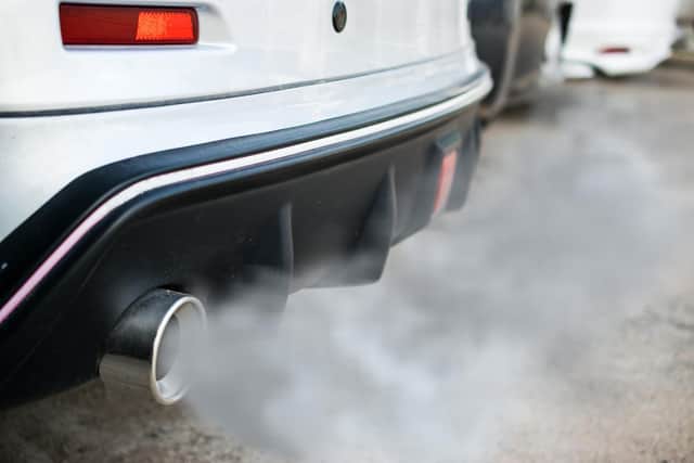 Car belching out fumes from its exhaust.
