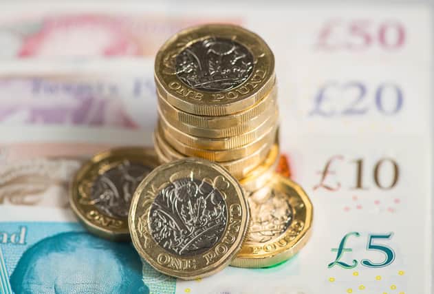 File photo dated 26/01/18 of a UK five pound, ten pound, twenty pound and fifty pound notes with one pound coins, as around 1.7 million workers will get a "significant" pay boost when the national minimum wage (NLW) increases from Saturday. A 92p rise to £10.42 an hour for workers aged 23 and over is equivalent to a near 10% increase, the Resolution Foundation said. Issue date: Friday March 31, 2023.