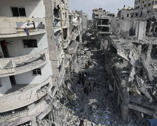 Palestinians look for survivors after the Israeli bombardment of the Gaza Strip in Deir Al-Balah. Picture: AP Photo/Hatem Moussa