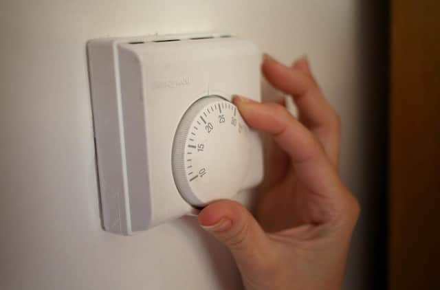 Undated file photo of a person using a central heating thermostat. All households in England, Scotland and Wales will receive £400 in energy bill discounts from October, the Government has announced. The support will be issued in six instalments over six months to some 29 million households. Issue date: Friday July 29, 2022.