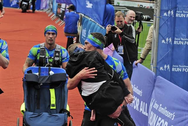 The powerful moment that Kevin Sinfield carried best friend Rob Burrow across the finish line at the Leeds Marathon earlier this year. Photo: Steve Riding.