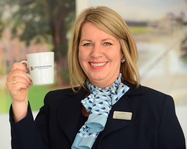 BG - A David Wilson Homes Sales Adviser holding a mug of tea
