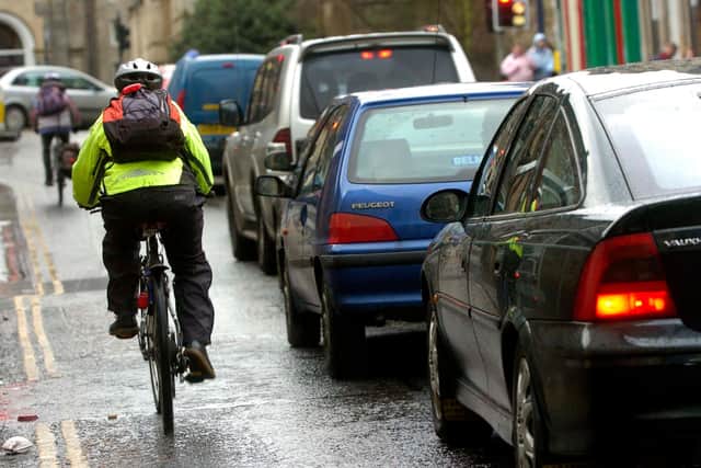 Cyclists/bikes and traffic/cars, rush hour, pollution, exhusts, fumes